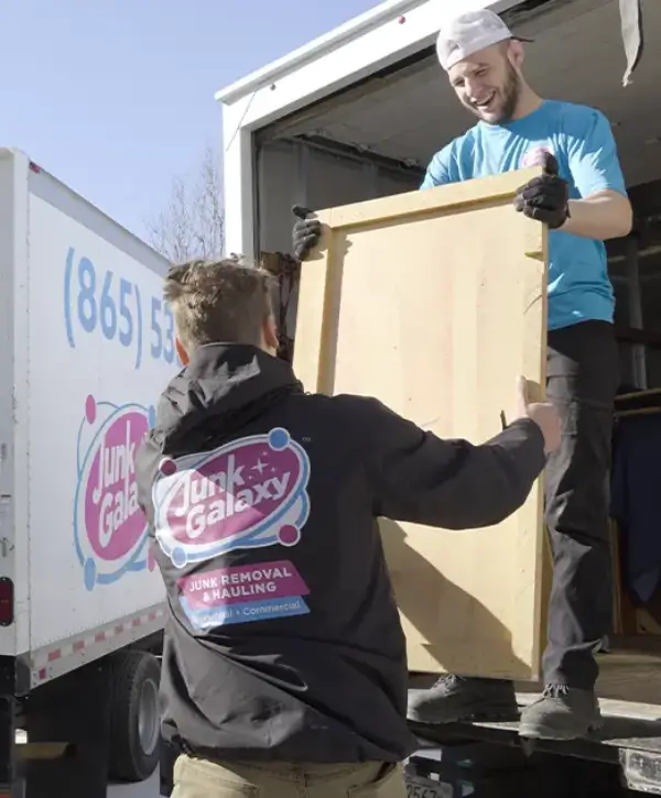 junk galaxy workers loading furniture into truck