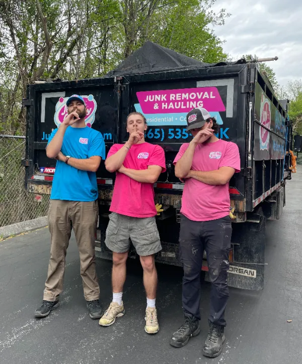 Junk galaxy workers posing in front of same day junk removal truck