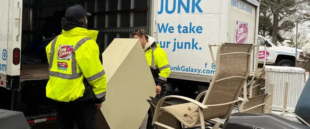 a junk removal service called Junk Galaxy, with two employees loading items into a company truck.