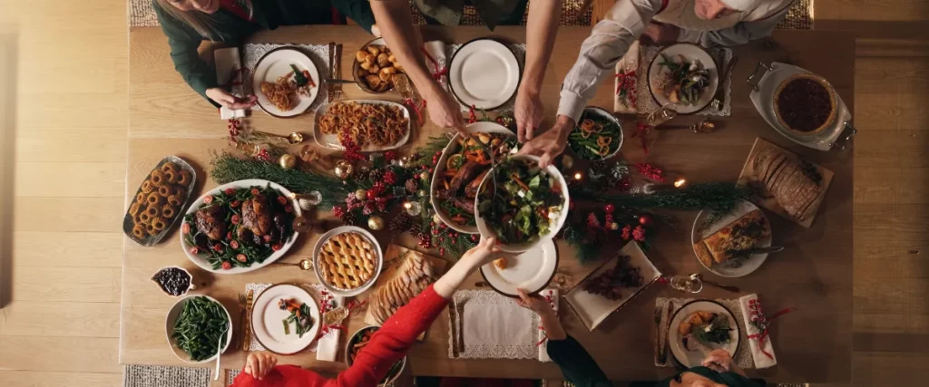 a top-down view of a festive holiday meal shared among a group of people