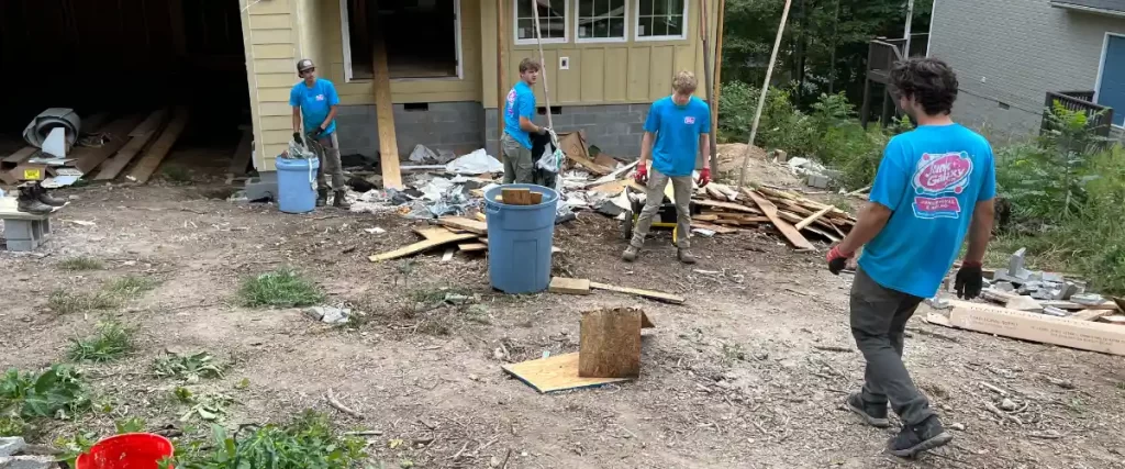 four junk galaxy workers sorting debris during a junk removal project
