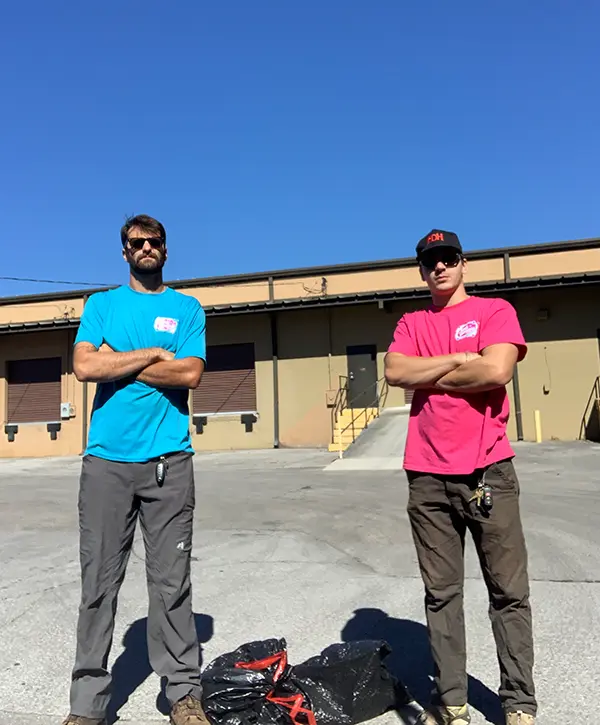 Junk removal team members after commercial debris cleanup and hauling service